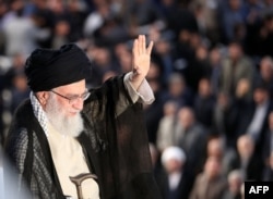 Supreme Leader Ayatollah Ali Khamenei greets the crowd on June 4, 2018, during a ceremony in Tehran on the occasion of the 29th anniversary of the death of the founder of the Islamic republic.