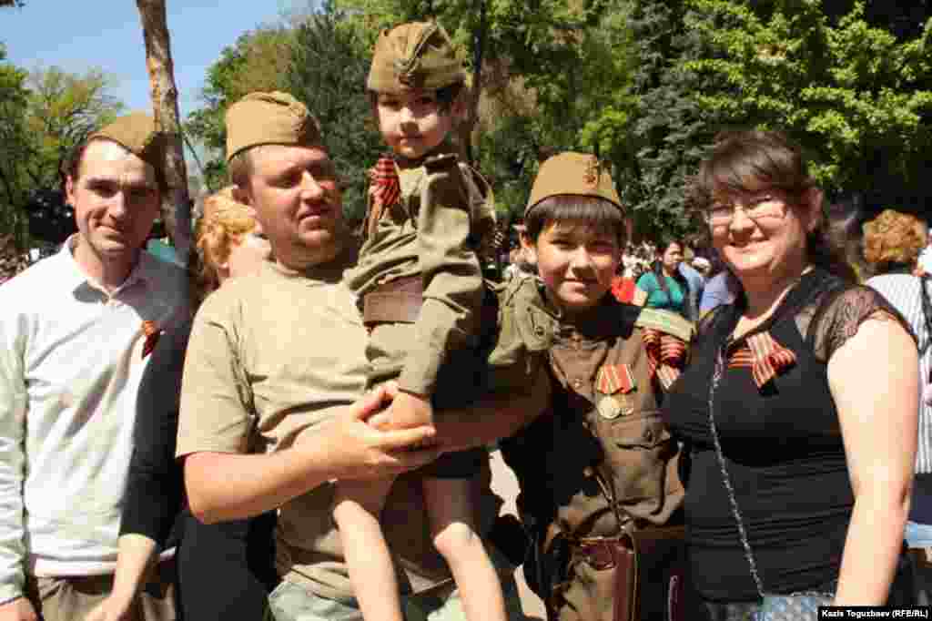 Family members wear the St. George Ribbon, a Russian symbol of military valor, in Almaty.