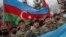 Azerbaijani soldiers with a national flag celebrate the transfer of the Lachin region to Azerbaijan's control on December 1.
