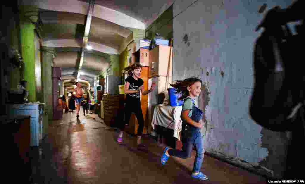 Children play in the long corridors to escape the cramped confines of their living quarters.&nbsp;