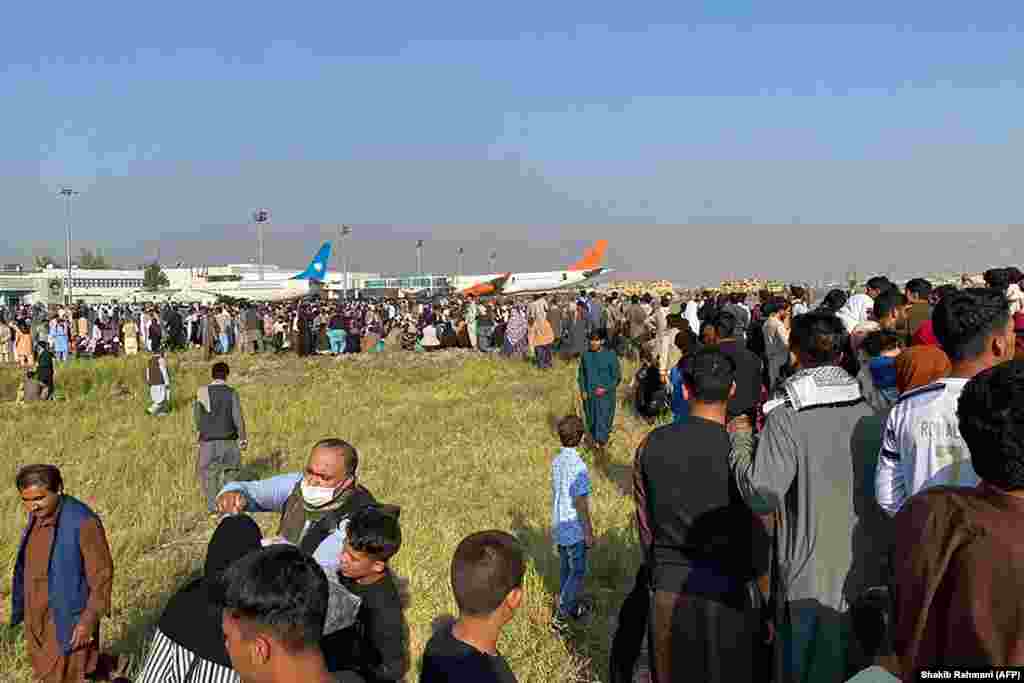 Afghans crowd at the airport as they wait to leave Kabul.&nbsp;