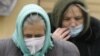 Belarus -- Elderly women wear protective masks in Minsk, 06Nov2009