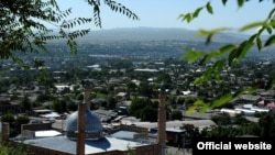 Kyrgyzstan -- A view of Souleymane mountain with new central mosque, Osh, 11Jul2012