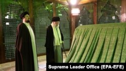 Iranian supreme leader Ayatollah Ali Khamenei (C) and Khomeini's grandson Hassan Khomeini (L) pray inside the shrine of late Iranian Supreme Leader Ayatollah Ruhollah Khomeini. FILE PHOTO