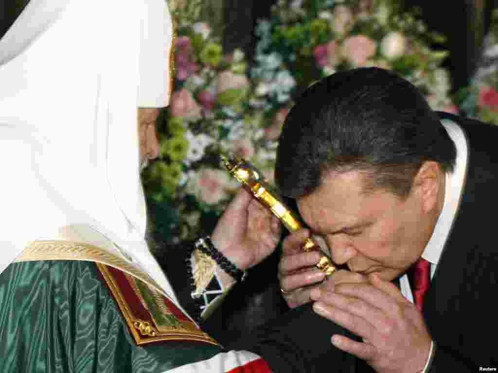 Ukrainian President-elect Viktor Yanukovych (right) at a service led by Patriarch of Moscow and All Russia Kirill. - Yanukovych attended a religious service before his inauguration at Kievo-Pecherskaya Lavra Cathedral in Kyiv on February 25. Photo by Vladimir Sindeyev for Reuters