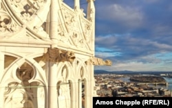 Gargoyles high on the steeple of the Matthias Church bask in the morning sunlight.