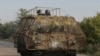 Украинские военнослужащие едут на БТР M113, оснащенным решетками для защиты от российских дронов, район Константиновки, Донецкая область, 24 августа 2025 года
