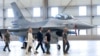 Ukrainian President Volodymyr Zelenskiy (second right) and Dutch Prime Minister Mark Rutte (center) inspect F-16 fighter jets in Eindhoven, Netherlands, on August 20.