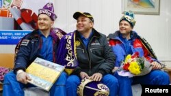 ISS crew members Alexander Gerst of Germany (left), Maxim Surayev of Russia (center), and Reid Wiseman of the United States after their landing in Kazakhstan