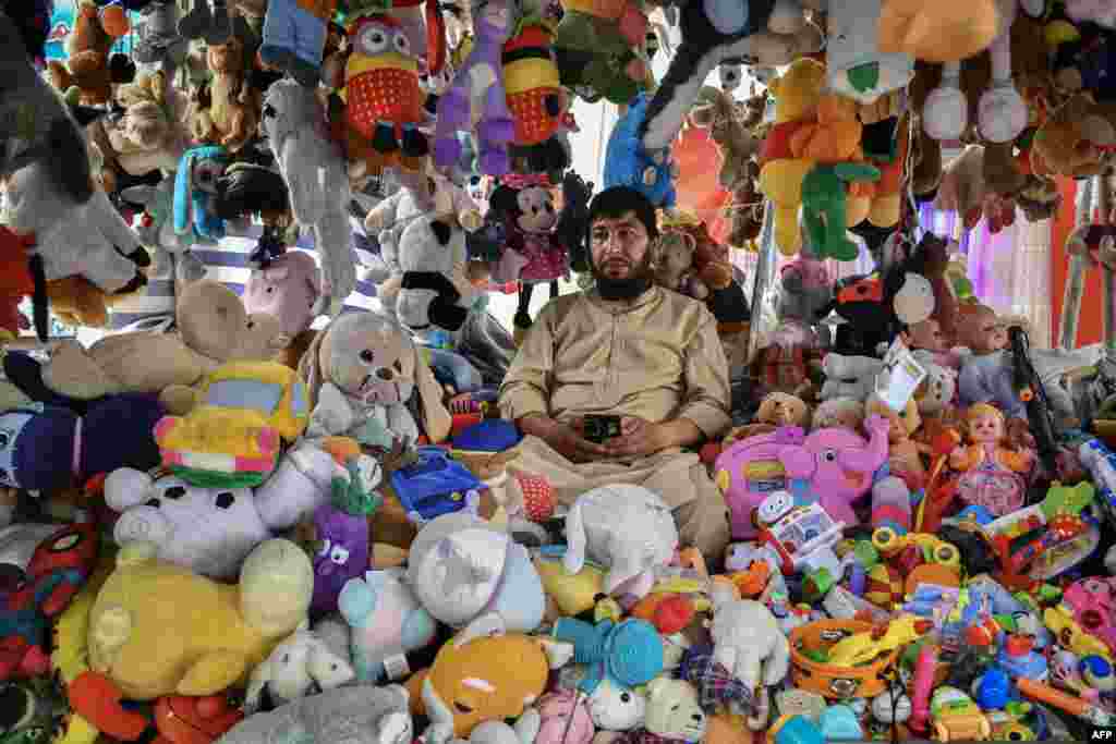 An Afghan vendor selling toys waits for customers at a market in Mazar-i-Sharif.