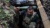 Военный 30-й ОМБр ВСУ несет снаряд для самоходной гаубицы 2С1 «Гвоздика» на передовой в Донецкой области, 13 августа 2025 года