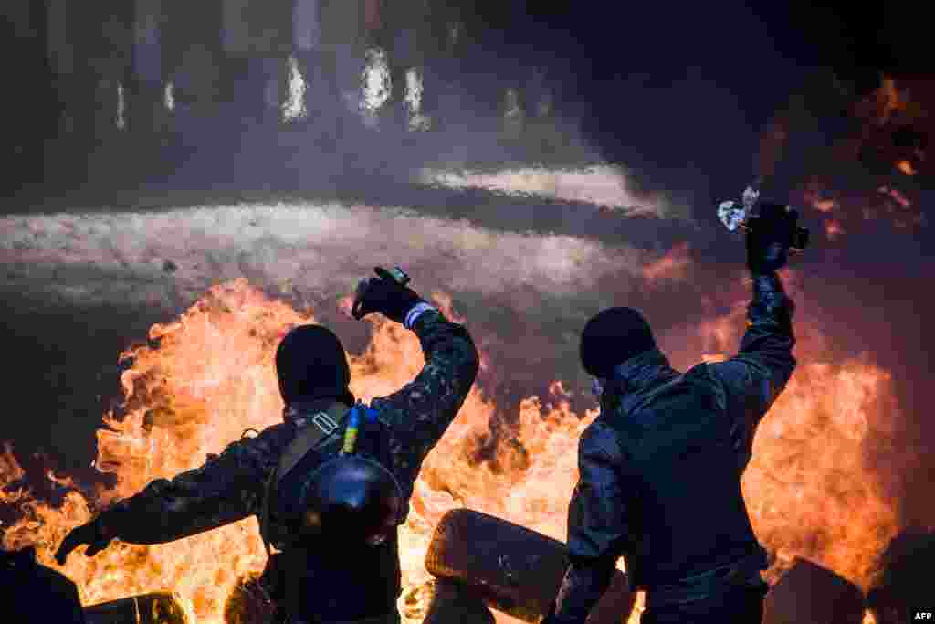 Antigovernment demonstrators clash with riot police on February 18.