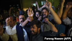 Supporters of former Pakistani Prime Minister Nawaz Sharif shout slogans during his arrival from jail at the cardiac center at the Pakistan Institute of Medical Sciences in Islamabad on July 29.