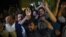 Supporters of former Pakistani Prime Minister Nawaz Sharif shout slogans during his arrival from jail at the cardiac center at the Pakistan Institute of Medical Sciences in Islamabad on July 29.