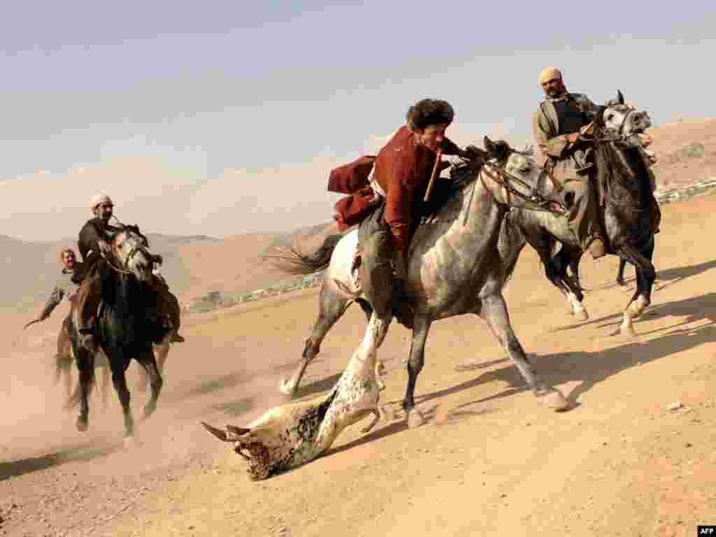 Afghan horsemen compete for a goat carcass during a game of buzkashi in Kabul.