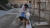 Moldova, Viorica, a volunteer feeds homeless dogs with the food donated by a private kindergarten