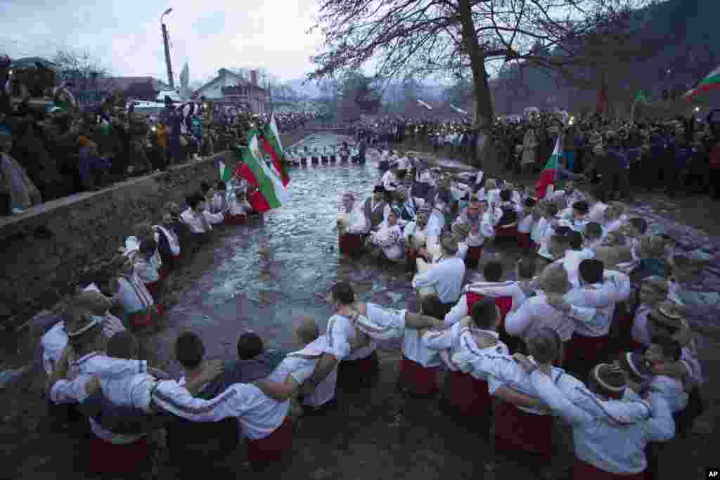 Bulgarians sing and dance in the icy waters of the Tundzha River in Kalofer on January 6. (AP)