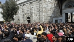 Hundreds of people march from the Omayyed mosque in the center of Damascus.