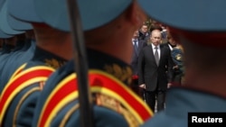 President Vladimir Putin is seen past Russian soldiers at a ceremony at the Tomb of the Unknown Soldier in Moscow in 2012.