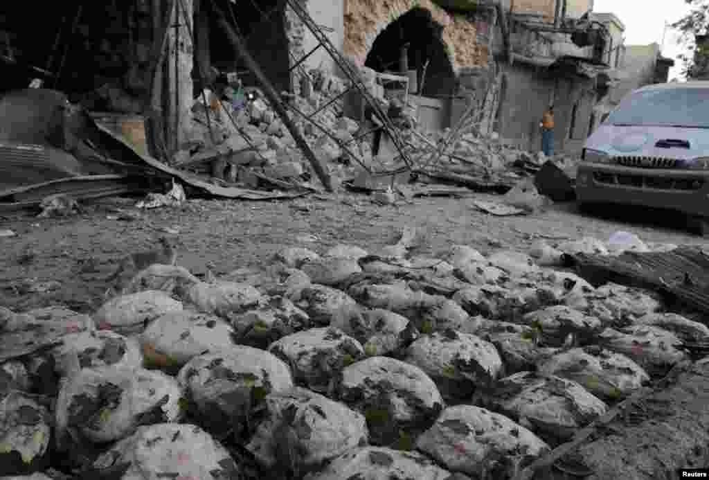 Loaves of bread are arranged at the scene of an air strike in the rebel-held Bab al-Maqam neighborhood of Aleppo, Syria. (Reuters/Abdalrhman Ismail) 