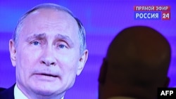 Russian President Vladimir Putin answering questions on TV during the annual Direct Line session on Russian TV channels and radio stations last year.