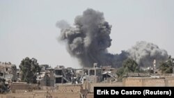 Smoke rises at the positions of Islamic State militants after an air strike by U.S.-led coalition forces at the front line in Raqqa, Syria, on October 5.