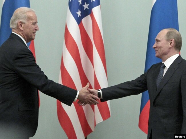 Then-Russian Prime Minister Vladimir Putin (right) meets with then-U.S. Vice President Joe Biden in Moscow in March 2011.