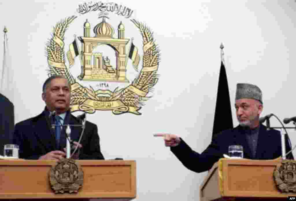 Afghan President Hamid Karzai gestures toward visiting Pakistani Prime Minister Shaukat Aziz in January 2007 - Afghan officials first suggested that insurgents or terrorists were crossing over from Pakistan in 2003, triggering an attack on Pakistan's embassy by an angry mob. Relations have run hot and cold ever since.