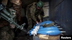 Ukrainian soldiers prepares mortar shells before firing them toward positions of Russian troops on the outskirts of Bakhmut on December 30.