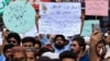 FILE: People shout slogans during a protest to support Khalid Khan, the man who allegedly killed Tahir Nasim, a man accused of blasphemy inside a court in the northwestern city of Peshawar on July 31.
