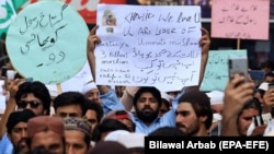 FILE: People shout slogans during a protest to support Khalid Khan, the man who allegedly killed Tahir Nasim, a man accused of blasphemy inside a court in the northwestern city of Peshawar on July 31.