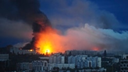 Fire and smoke rise from the site where a Russian missile struck a residential area in Kharkiv, Ukraine on June 7.