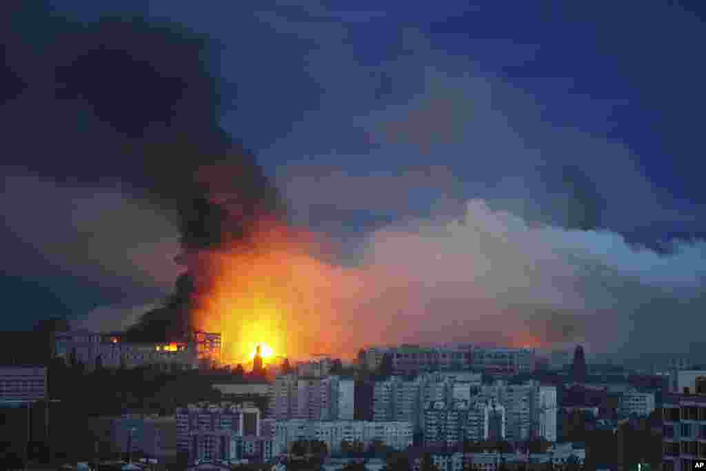 Fire and smoke rise from the site where a Russian missile struck a residential area in Kharkiv, Ukraine, on June 7.