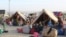 Afghan refugees rest in tents at a makeshift shelter camp in Pakistan.