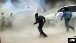  A video grab allegedly shows people running for cover as a roadside bomb explodes in front of a UN observers convoy in Syria earlier this month. 