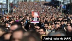 More than 15,000 people marched in Belgrade on March 12 in silence to mark the 10th anniversary of the assassination of Serbian Prime Minister Zoran Djindjic.