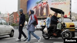 A banner picturing Iran's new supreme leader Mojtaba Khamenei with late supreme leader Ayatollah Ali Khamenei, in Tehran.