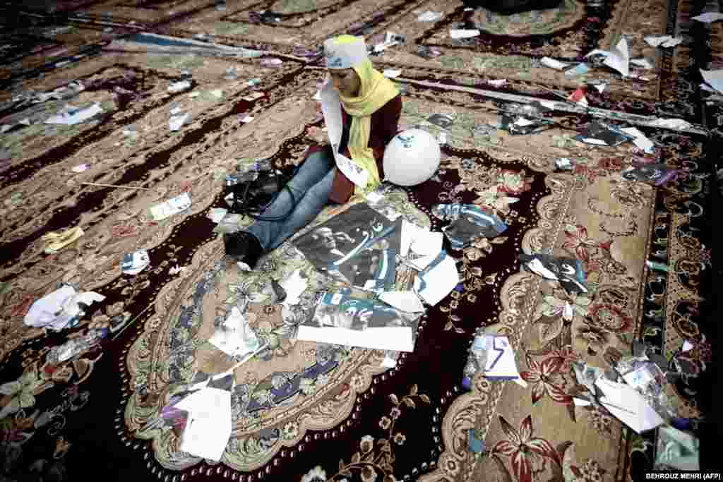 A supporter of Vice President Mohammad Reza Aref, a reformist presidential candidate, is surrounded by campaign materials after a rally in Tehran on June 10, ahead of the June 14 election that gave moderate candidate Hassan Rohani the presidency.