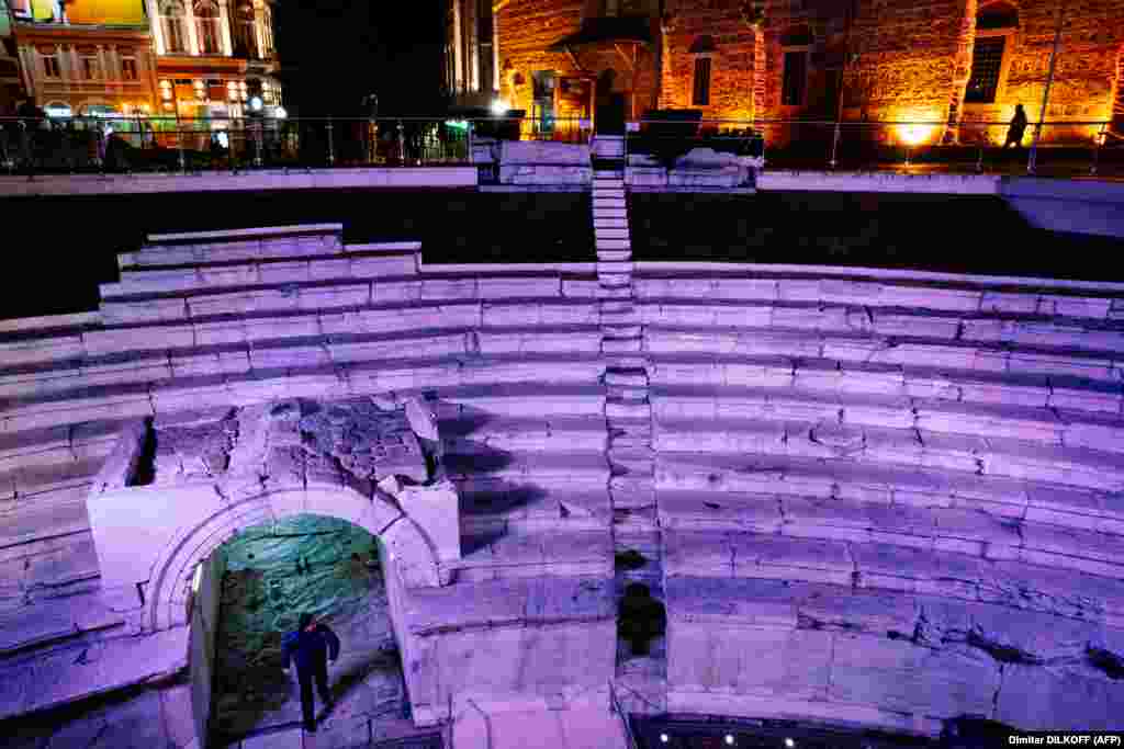An ancient Roman stadium in Plovdiv is illuminated at night. The city has architectural landmarks from the Thracian, Greek, Roman, Byzantine, and Ottoman eras, among others.