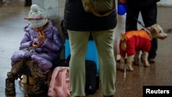 People take shelter inside a metro station during a Russian military strike in Kyiv on January 15.