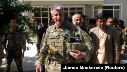 U.S. Army General John Nicholson, commander of Resolute Support forces and U.S. forces in Afghanistan, walks with Afghan officials during an official visit in Farah Province last month.