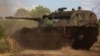 Ukrainian soldier ride a German self-propelled Panzerhaubitze 2000, with the inscription "Good evening, we are from Ukraine!" near the front line. in the Donbas region on July 12.