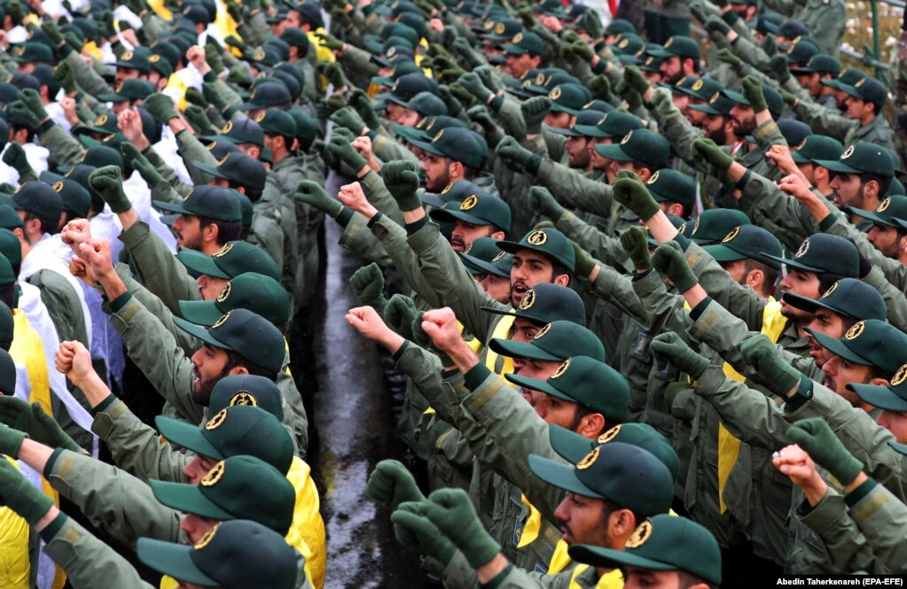 Members of the Islamic Revolutionary Guards Corps raise their fists while shouting slogans on Azadi (Freedom) Square in Tehran.