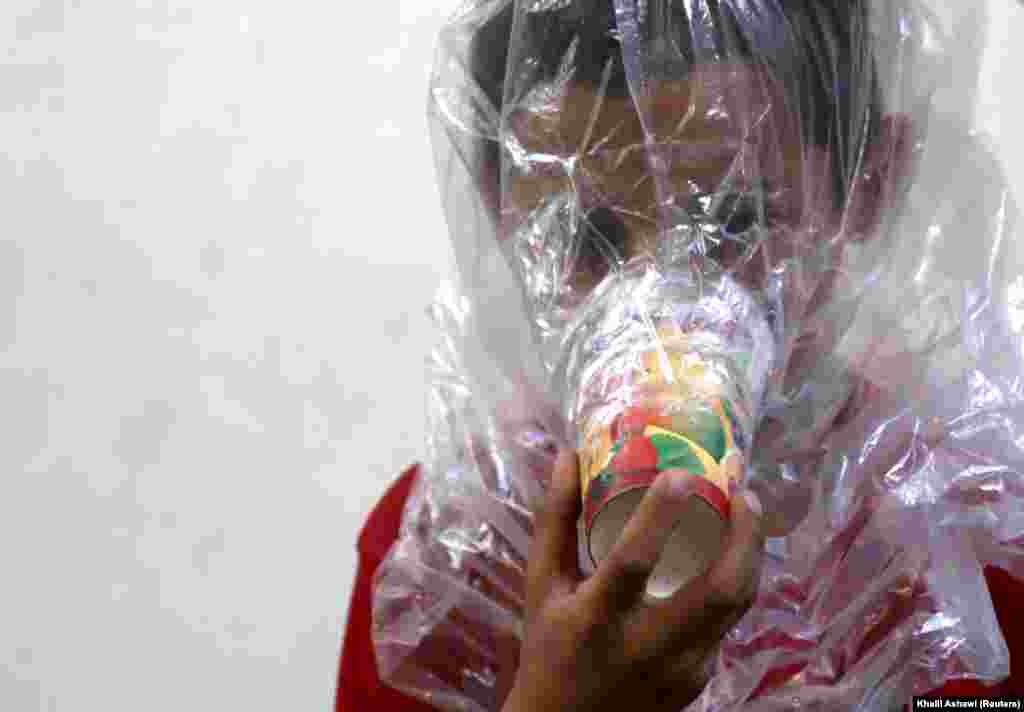A boy tries on an improvised gas mask in Idlib, Syria, on September 3. (Reuters/Khalil Ashawi)