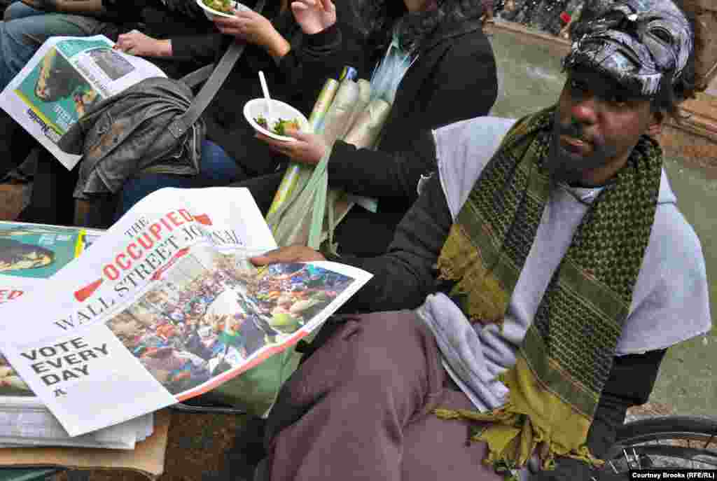 A protester hands out copies of the movement&#39;s newsletter, &quot;The Occupied Wall Street Journal,&quot; in New York City&#39;s Bryant Park.