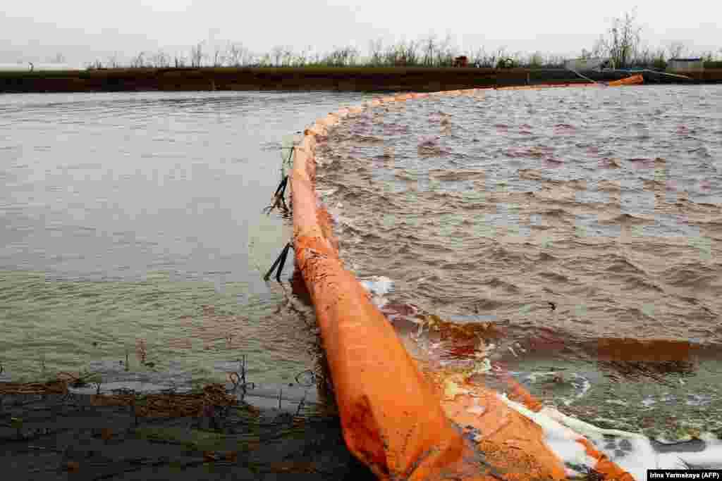 A floating dam is installed to limit the spread of pollution in the Ambarnaya River outside Norilsk after the oil spill in May. The accident happened when a fuel reservoir collapsed at a power plant operated by a subsidiary of metals giant Norilsk Nickel.