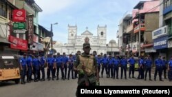 Sri Lankan military stand guard in front of the Kochchikade church after an explosion in Colombo