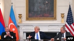 U.S. President Donald Trump (C), Azerbaijani President Ilham Aliyev (L) and Armenian Prime Minister Nikol Pashinian react after signing an agreement in Washington on August 8, 2025.
