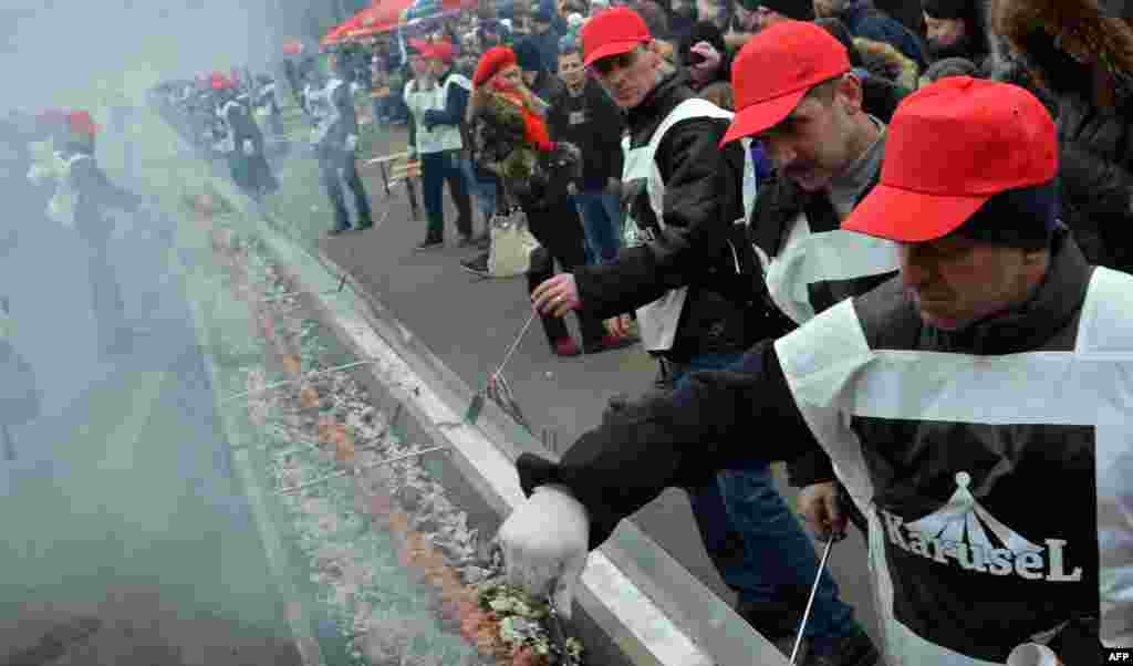 Volunteers cook shashlyk, or a skewer of meat, measuring 150.6 meters in length in the Ukrainian capital, Kyiv, to set a new world record. Shashlyk is a popular food item throughout the former Soviet Union, Eastern Europe, India, Iran, Mongolia, Morocco, Pakistan, and Israel. (AFP/Sergei Supinsky)