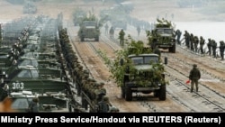 Troops transport trucks on a pontoon bridge across a river during joint military exercises held by Russia and Belarus in September.